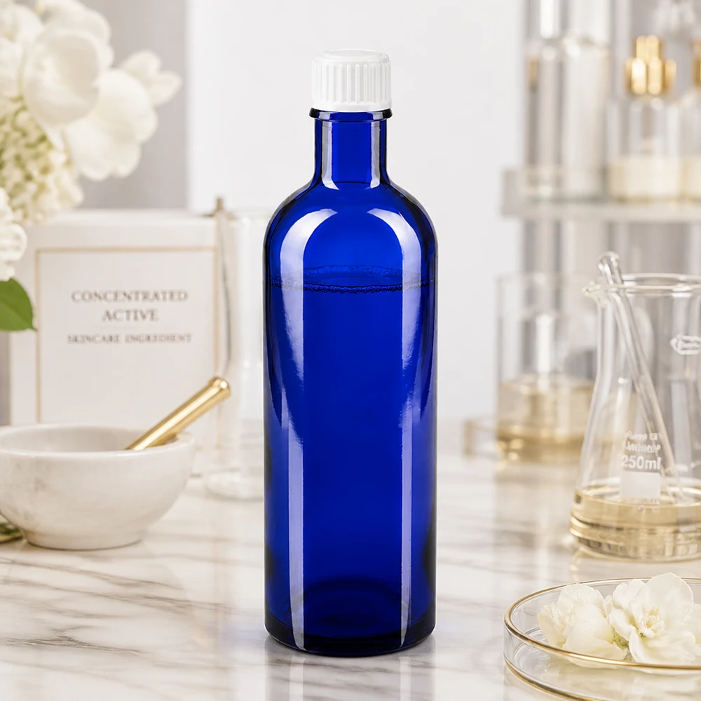 Flacon de pharmacie bleu cobalt de 200 ml avec protection UV, en verre borosilicaté et muni d'un bouchon blanc