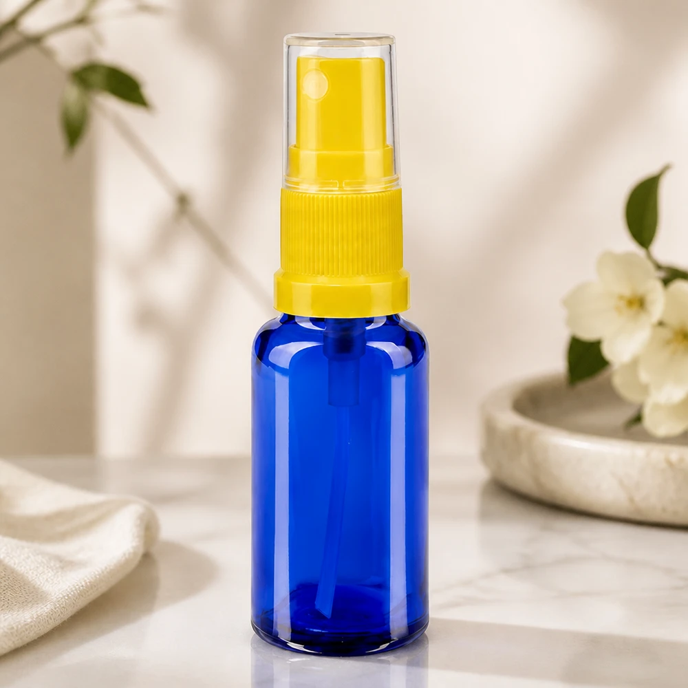 Flacon pulvérisateur compact de pharmacie, 20 ml, en verre bleu, avec pompe jaune et bouchon transparent