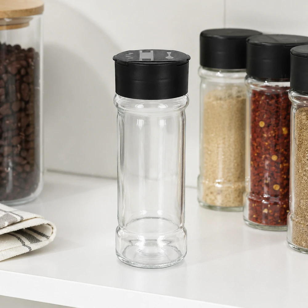Pot à sel/épices 100 ml avec double saupoudreuse, noir Pot à épices cylindrique de 100 ml avec un saupoudreur double noir, à côté de flocons de piment et de sésame